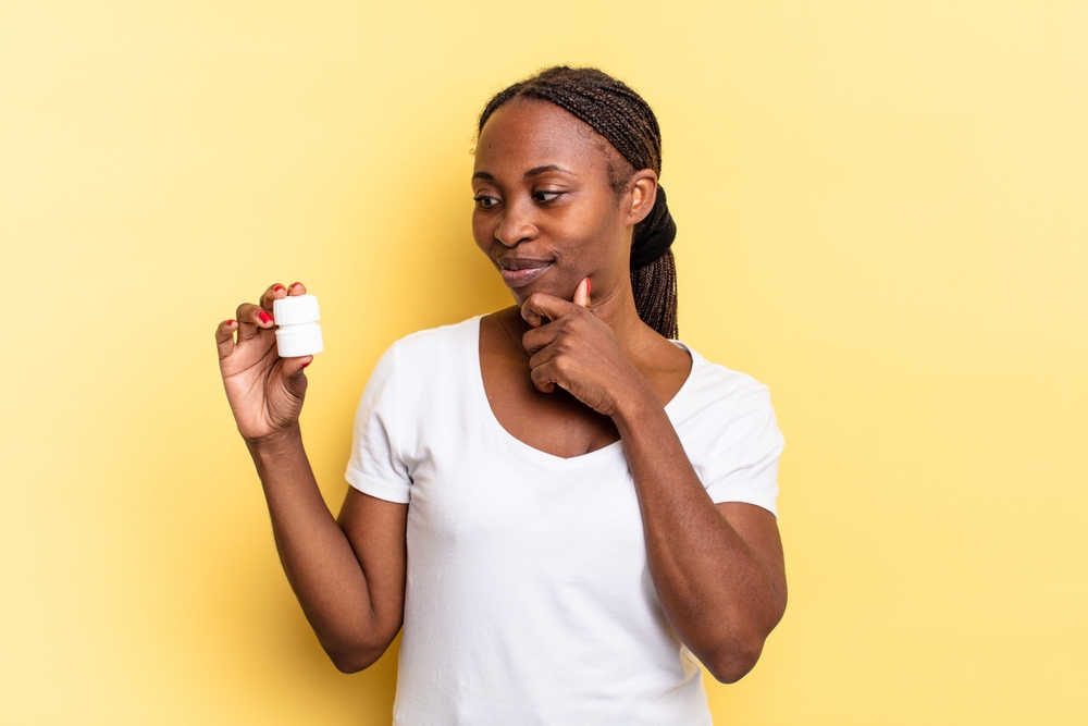 woman looking at bottle of peptides for fat burning in Maryland